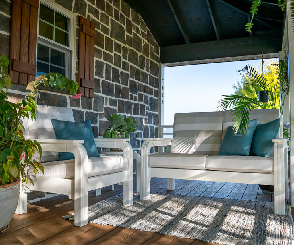 Outdoor Furniture 21 Outdoor furniture seating set with poly loveseat and chairs on a covered porch.