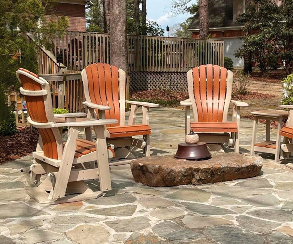 Poly vs. Wood Outdoor Furniture: Which Should You Choose? 7 Poly Adirondack chairs around fire pit on open stone patio