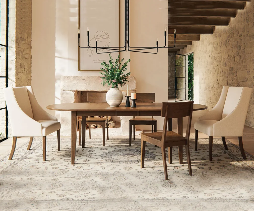 Oval wood dining table paired with upholstered and wood chairs in a warm, modern dining room.